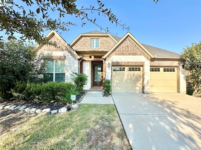 craftsman-style house featuring a front lawn and a garage