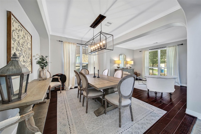 dining area with ornamental molding and a notable chandelier