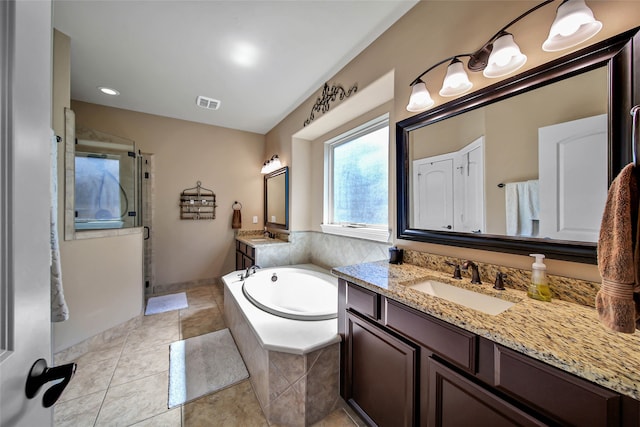 bathroom with tile patterned floors, vanity, and shower with separate bathtub