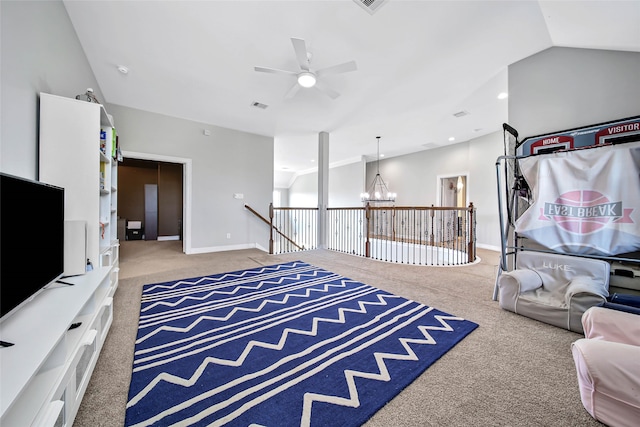 living room with carpet flooring, lofted ceiling, and ceiling fan with notable chandelier