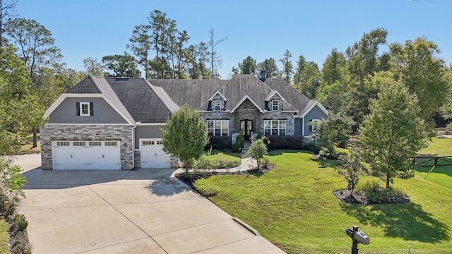 craftsman-style house featuring a garage and a front lawn