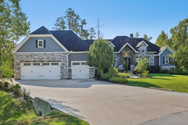 craftsman house with a garage and a front yard