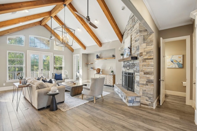 38134 Cascade Ct, Magnolia, TX 77354 - living area with beamed ceiling, wood finished floors, a fireplace, french doors, and high vaulted ceiling