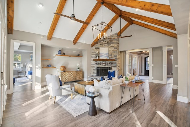 38134 Cascade Ct, Magnolia, TX 77354 - living room with high vaulted ceiling, a chandelier, wood finished floors, a ceiling fan, and beamed ceiling