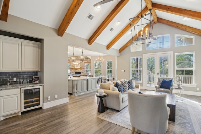 living room with high vaulted ceiling, beverage cooler, plenty of natural light, and dark hardwood / wood-style flooring