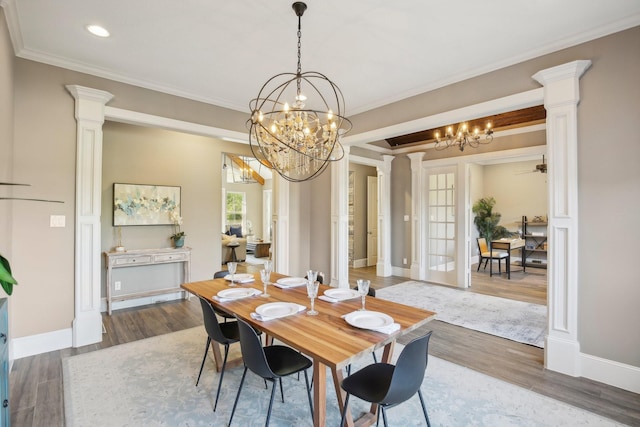 38134 Cascade Ct, Magnolia, TX 77354 - dining area featuring ornate columns, a chandelier, ornamental molding, wood finished floors, and recessed lighting