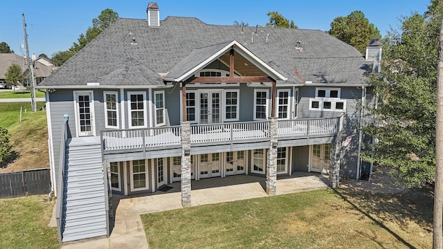 rear view of property with a deck, a patio, and a yard