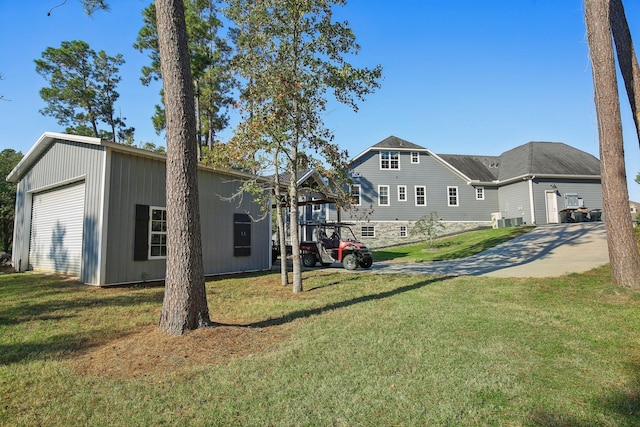 38134 Cascade Ct, Magnolia, TX 77354 - view of green lawn with an outdoor structure and a garage