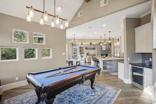 38134 Cascade Ct, Magnolia, TX 77354 - playroom with wine cooler, dark wood-type flooring, billiards table, recessed lighting, and high vaulted ceiling