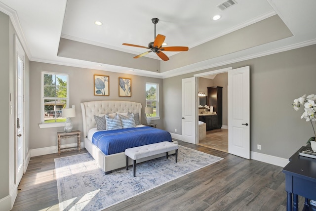 38134 Cascade Ct, Magnolia, TX 77354 - bedroom featuring a tray ceiling, wood finished floors, ornamental molding, connected bathroom, and recessed lighting