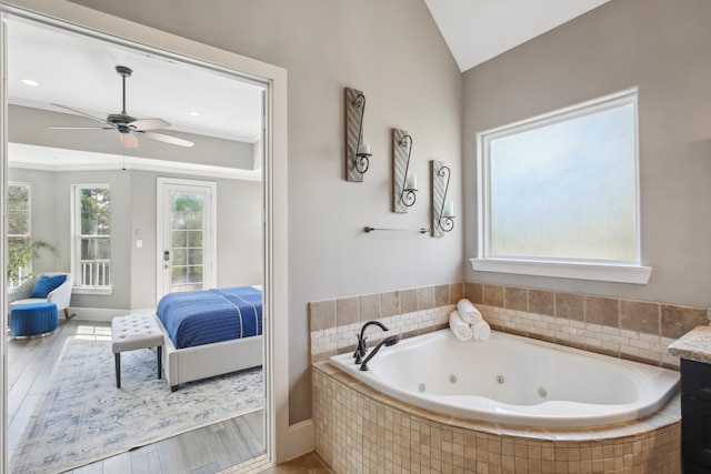 bathroom featuring hardwood / wood-style flooring, a healthy amount of sunlight, and lofted ceiling