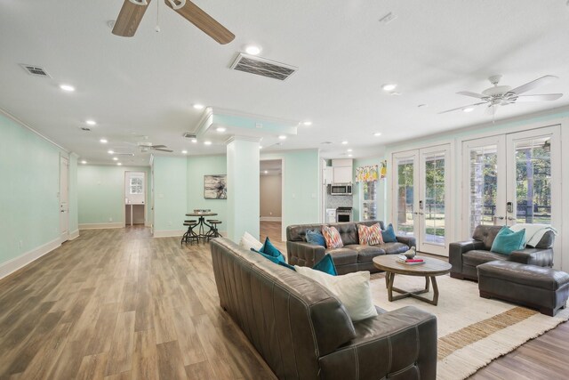 38134 Cascade Ct, Magnolia, TX 77354 - living room featuring a ceiling fan, light wood finished floors, recessed lighting, and french doors