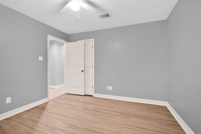 spare room featuring light hardwood / wood-style floors and ceiling fan