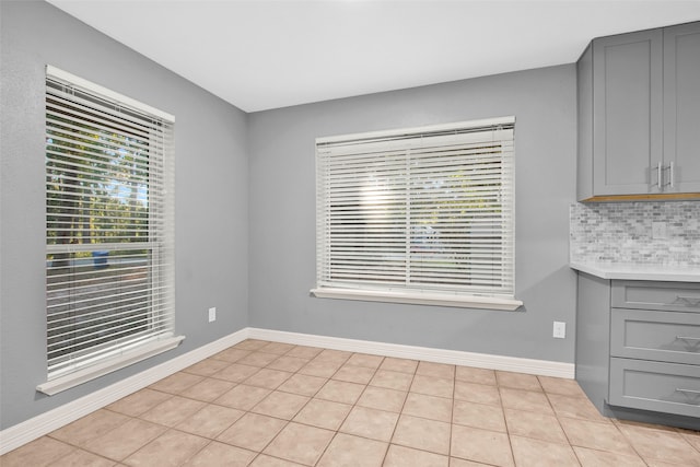 unfurnished dining area featuring light tile patterned floors