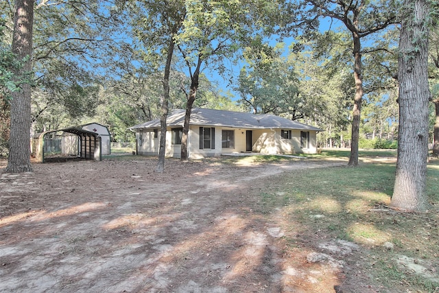 view of front of home featuring a shed and a carport