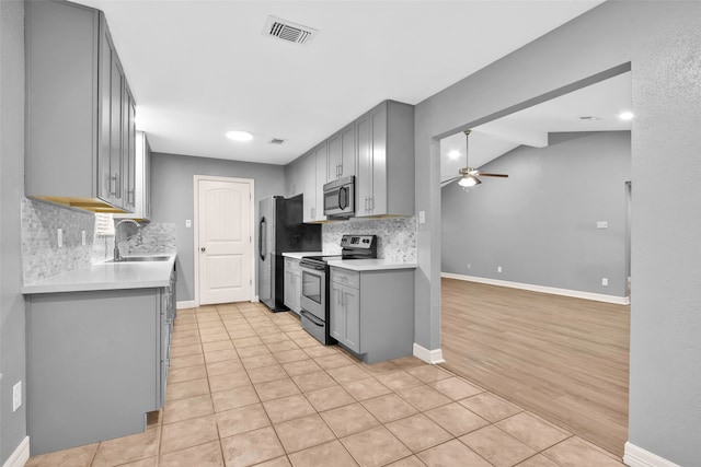 kitchen featuring gray cabinets, sink, stainless steel appliances, and light hardwood / wood-style floors