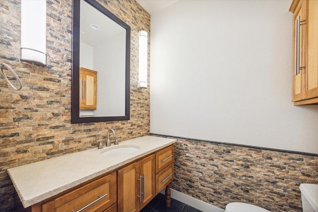 bathroom featuring toilet, vanity, and tile patterned floors