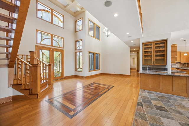 foyer featuring a chandelier, wood-type flooring, and plenty of natural light