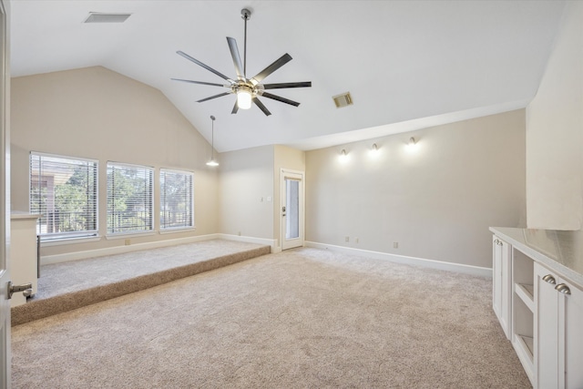 unfurnished room featuring light carpet, lofted ceiling, and ceiling fan