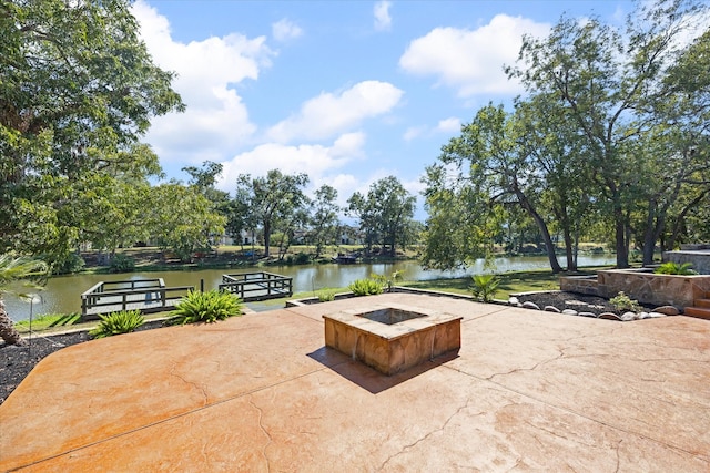 view of patio / terrace featuring a water view and a fire pit