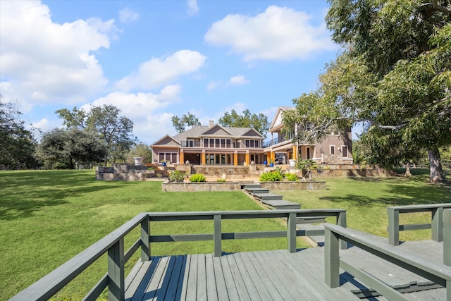 rear view of house with a yard and a deck