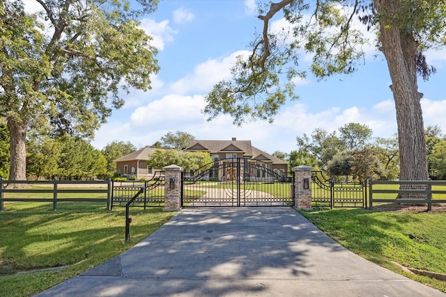 view of gate with a lawn