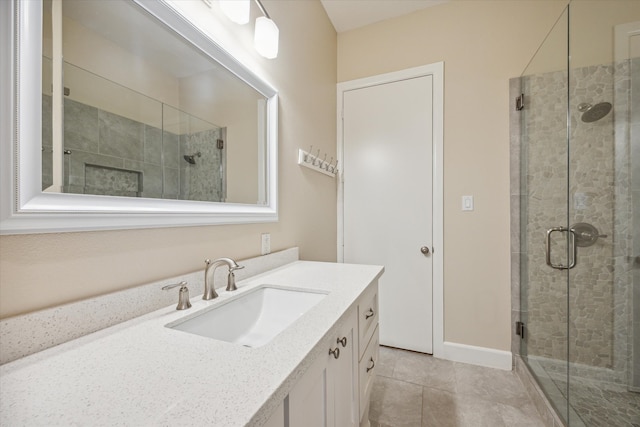 bathroom with vanity, an enclosed shower, and tile patterned floors