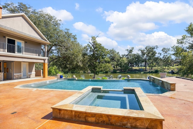 view of pool featuring a patio, an in ground hot tub, pool water feature, and a water view