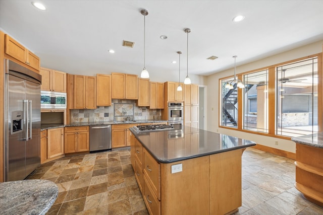 kitchen featuring built in appliances, backsplash, a center island, and pendant lighting