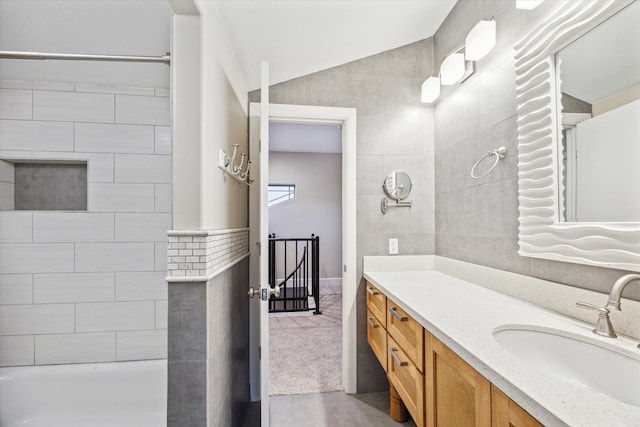 bathroom featuring vanity and lofted ceiling