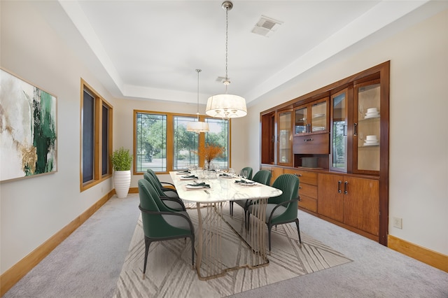 dining room featuring a notable chandelier and light colored carpet