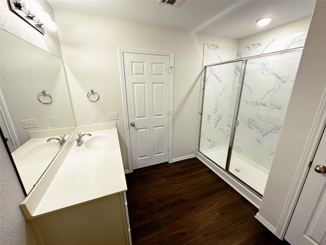 bathroom featuring vanity, hardwood / wood-style flooring, and walk in shower