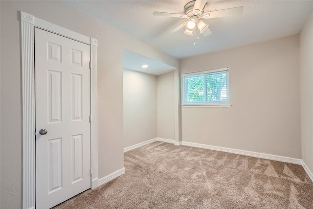 empty room featuring carpet and ceiling fan