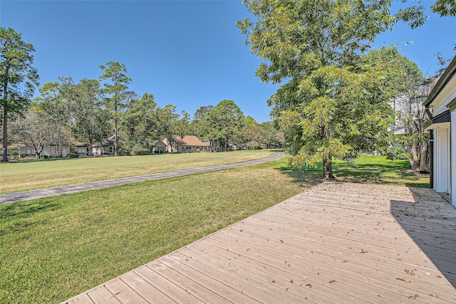 wooden terrace with a lawn