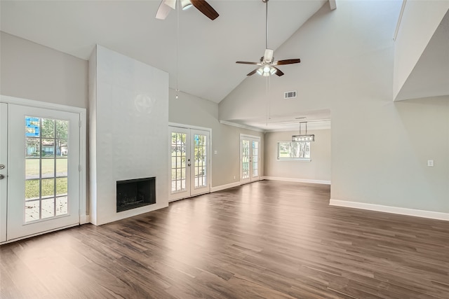 unfurnished living room with french doors, ceiling fan, high vaulted ceiling, and dark wood-type flooring