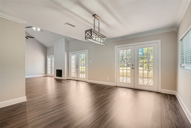 interior space with french doors, a textured ceiling, dark wood-type flooring, and lofted ceiling