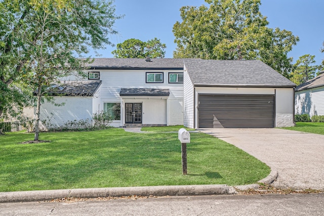 view of front of property with a front yard and a garage