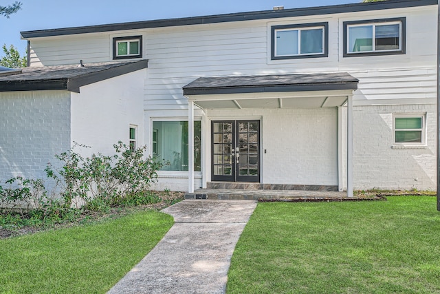 doorway to property featuring a lawn