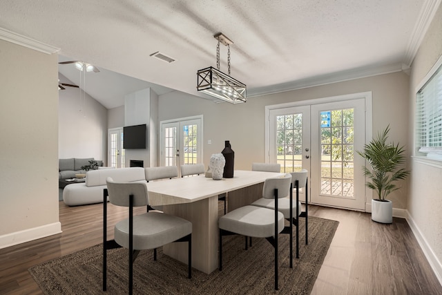 dining space featuring french doors, a healthy amount of sunlight, lofted ceiling, and dark hardwood / wood-style flooring