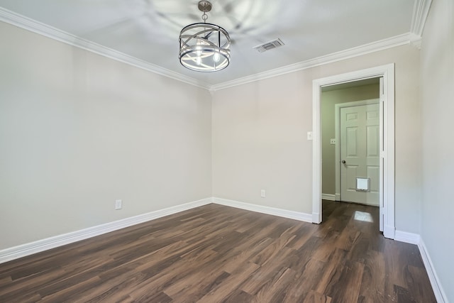 empty room featuring dark wood-type flooring, crown molding, and a notable chandelier