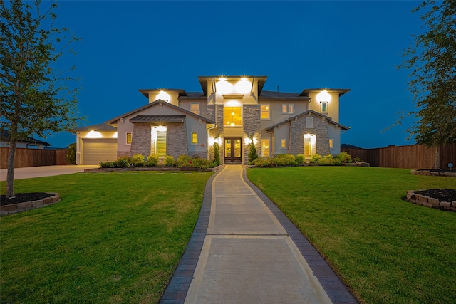 view of front of home with a yard and a garage