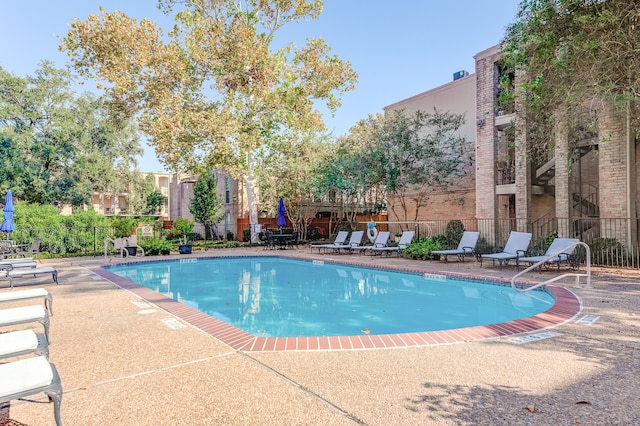 view of swimming pool with a patio