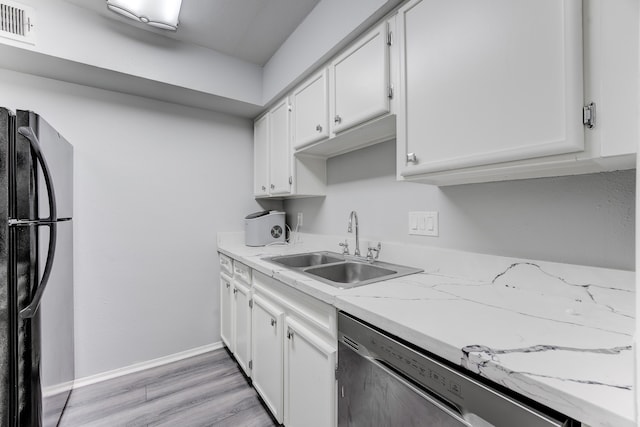 kitchen featuring dishwasher, black refrigerator, light hardwood / wood-style flooring, sink, and white cabinets