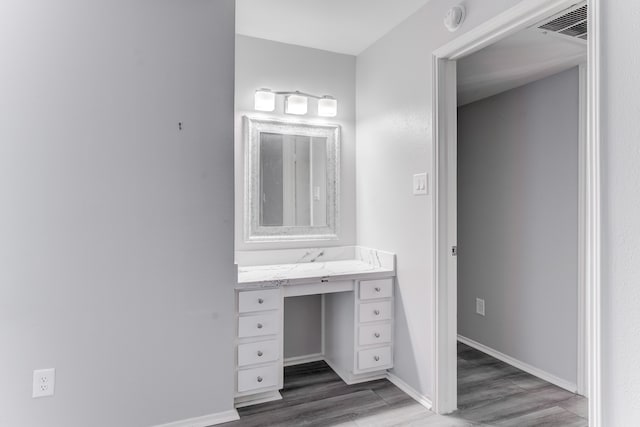 bathroom with vanity and wood-type flooring