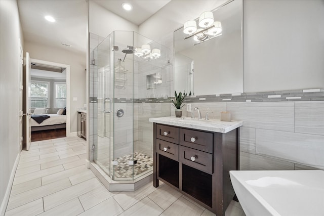 bathroom with vanity, plus walk in shower, and tile walls