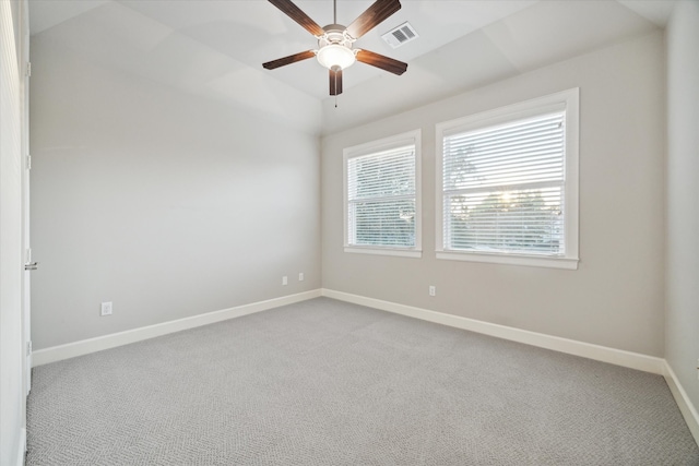 carpeted spare room featuring ceiling fan