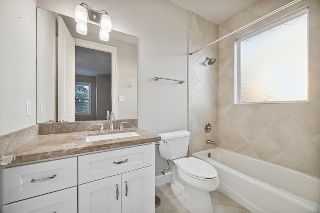 full bathroom with tiled shower / bath, vanity, toilet, and tile patterned flooring