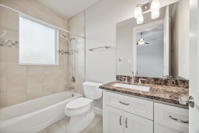 full bathroom featuring toilet, ceiling fan, tile patterned floors, tiled shower / bath, and vanity