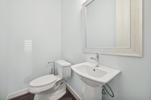 bathroom with wood-type flooring and toilet