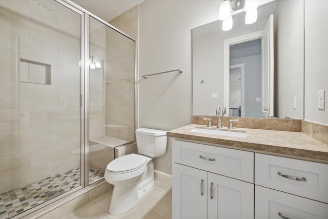 bathroom featuring vanity, tile patterned flooring, toilet, and an enclosed shower